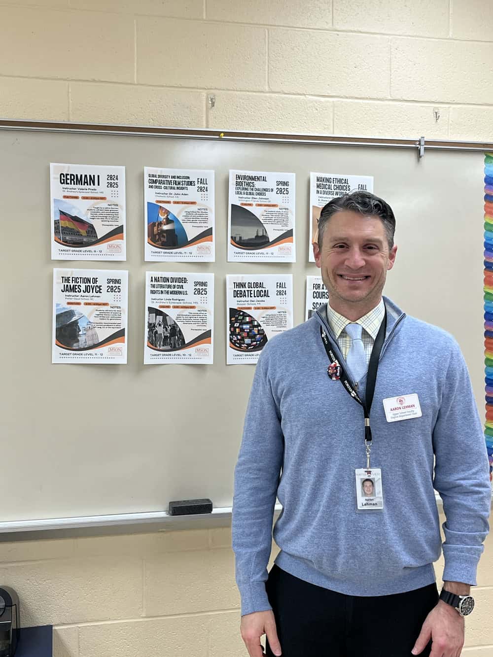 Male teacher standing in front of whiteboard